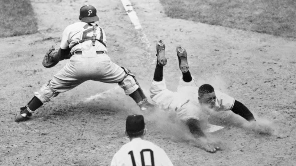 Willie Mays of the New York Giants slides safely into the plate on Wes Westrum's bases-full single in the sixth inning against the Philadelphia Phillies at the Polo Grounds, New York. - Bettmann Archive/Getty Images