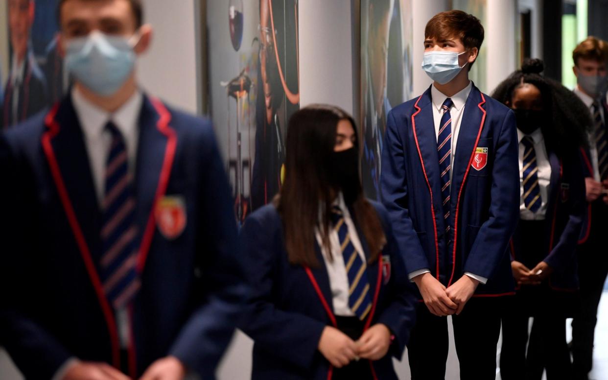 Students queue up for Covid tests at Harris Academy Beckenham, in London, ahead of schools reopening - REUTERS