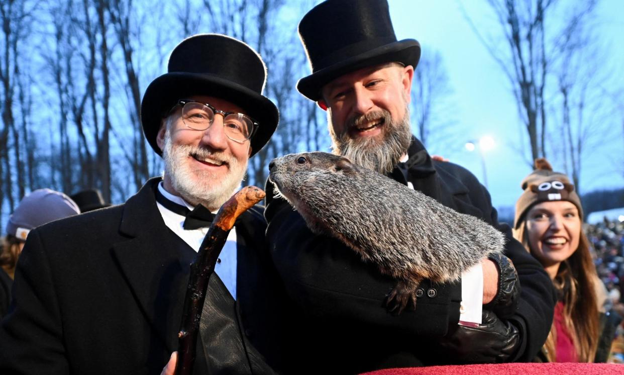 <span>Punxsutawney Phil and his two handlers in February.</span><span>Photograph: Alan Freed/Reuters</span>