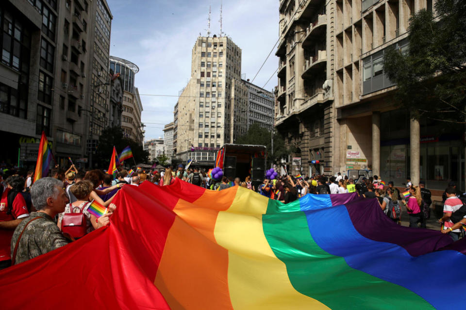 Participants hold a rainbow flag during an annual LGBT pride parade in Belgrade