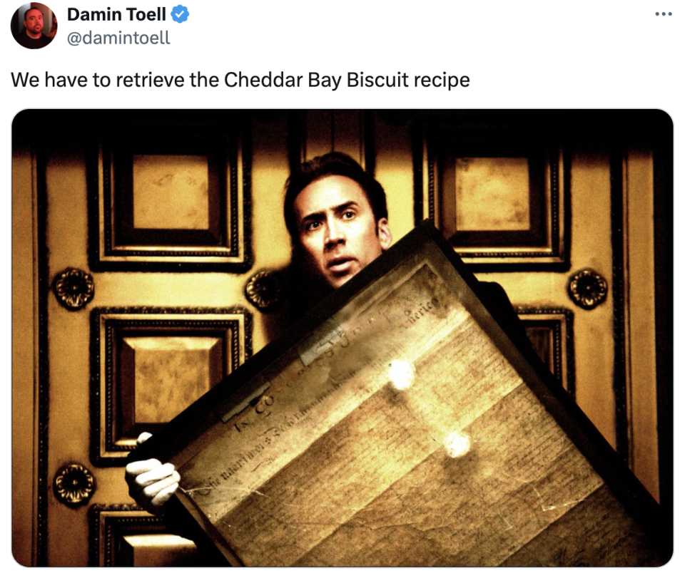 Nicolas Cage holding a framed document with text, caption reads, "We have to retrieve the Cheddar Bay Biscuit recipe."