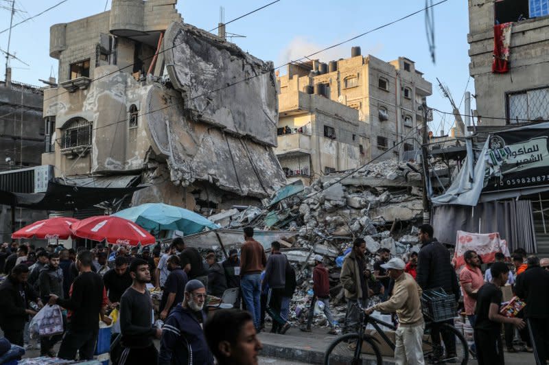 Palestinians purchase goods in a popular Rafah market Monday in preparation for the upcoming Muslim Eid al-Fitr celebrations, amid ruins left behind by Israeli attacks in the Gaza Strip. Muslims around the world started celebrating the Eid al-Fitr holiday Tuesday night, which marks the end of the fasting month of Ramadan with new clothes, toys and special sweets. Photo by Ismael Mohamad/UPI