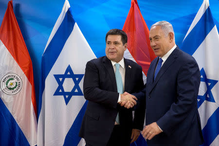 Paraguayan President Horacio Cartes shakes hands with Israeli Prime Minister Benjamin Netanyahu during a meeting at the Prime Minister's office in Jerusalem, following the dedication ceremony of the embassy of Paraguay in Jerusalem, May 21, 2018. Sebastian Scheiner/Pool via Reuters