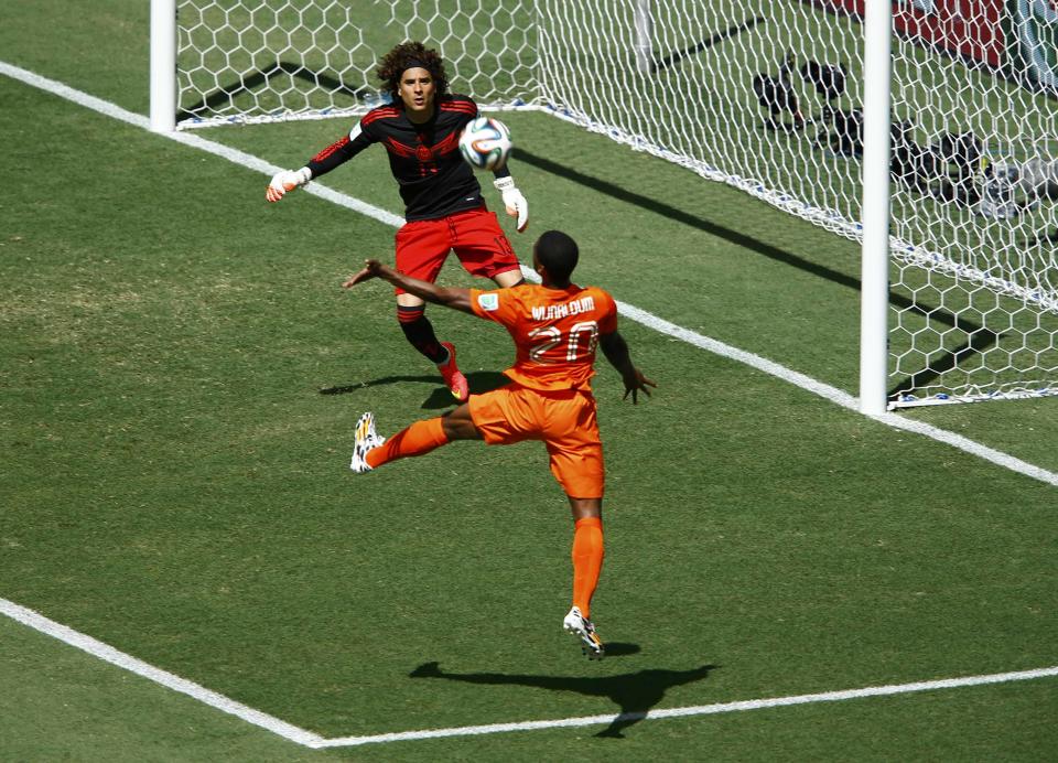 Wijnaldum of the Netherlands tries to head past Mexico's Ochoa during their 2014 World Cup round of 16 game at the Castelao arena in Fortaleza