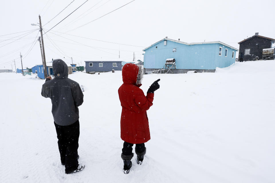 In this Monday, Jan. 20, 2020 photo, census workers verify that their maps match up to the right amount of houses in Toksook Bay, Alaska, a mostly Yup'ik village on the edge of the Bering Sea. Census workers traditionally begin the official decennial count in rural Alaska when the ground is still frozen. That allows easier access before the spring melt makes many areas inaccessible to travel and residents scatter to subsistence hunting and fishing grounds. The rest of the nation, including more urban areas of Alaska, begin the census in mid-March. (AP Photo/Gregory Bull)