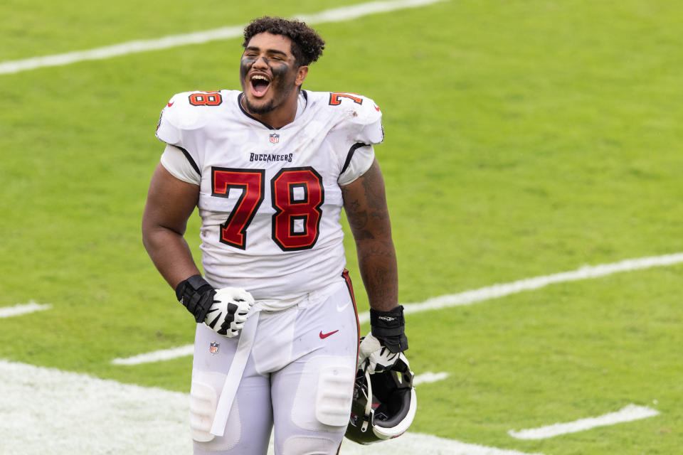 Helmetless Tristan Wirfs in a white Buccaneers uniform