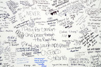 Handwritten messages are left at the memorial site at the memorial site on Tuesday, Dec. 7, 2021 outside Oxford High School in Oxford, Mich., after a 15-year-old allegedly killed these four classmates, and injured seven others in a shooting inside the northern Oakland County school one week earlier. (Jake May/The Flint Journal via AP)