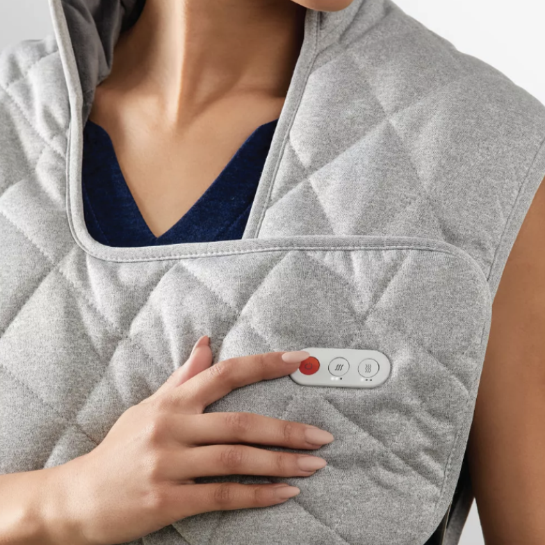 woman wearing grey Sharper Image Weighted Neck and Back Heat Massager Wrap (Photo via Bed Bath & Beyond)