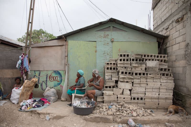 Vendors sit in Caradeux, a camp for people displaced by the January 2010 earthquake, in Port-au-Prince