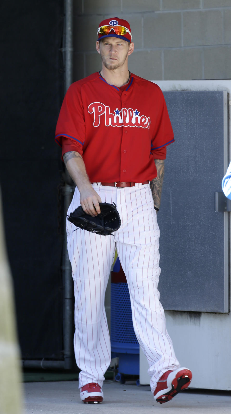 Philadelphia Phillies pitcher A.J. Burnett walks to the field before a spring training baseball practice Sunday, Feb. 16, 2014, in Clearwater, Fla. (AP Photo/Charlie Neibergall)