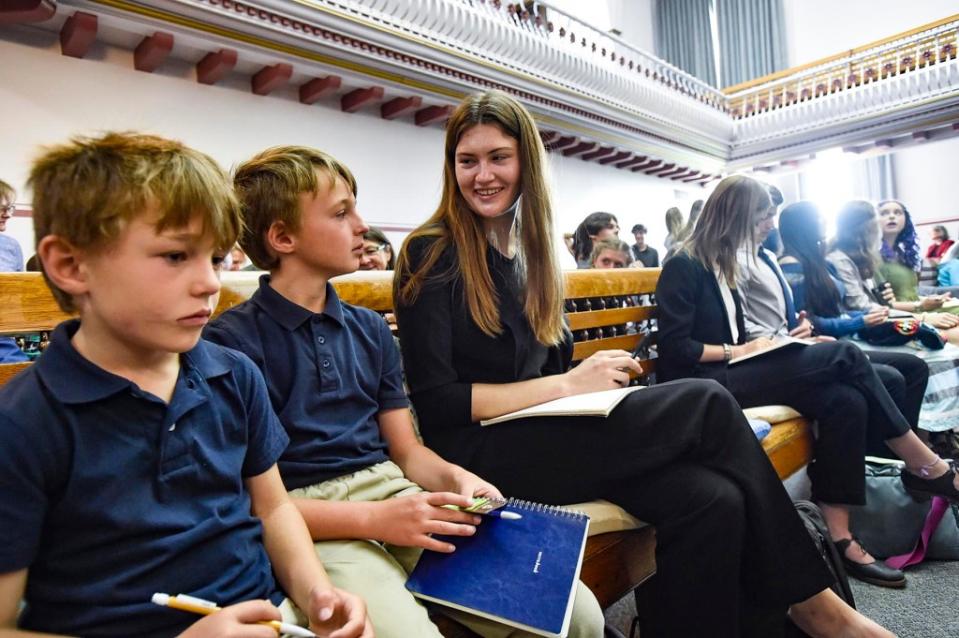 Plaintiff Rikki Held, center, talks with other plaintiffs before a hearing in the climate change lawsuit, Held vs. Montana, at the Lewis and Clark County Courthouse in Helena, Mont., on Monday, June 12, 2023. (Thom Bridge/Independent Record via AP)