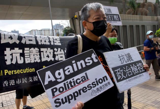 Pro-democracy activist Lee Cheuk-yan holds placards as he arrives at a court in Hong Kong in April. A report released Monday found that democracy is deteriorating around the world. (Photo: Associated Press)
