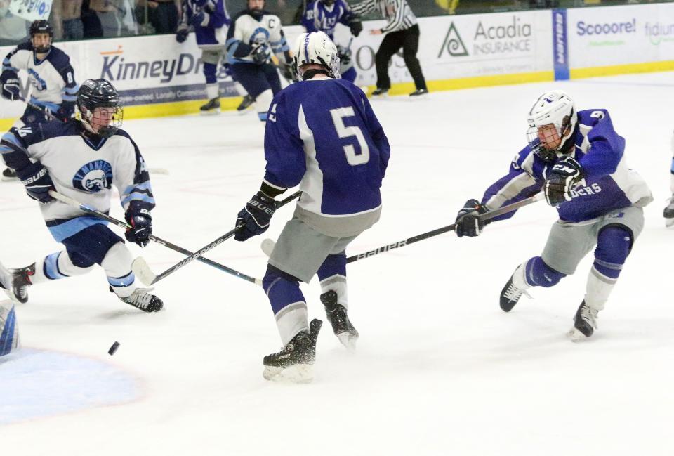 U-32 senior Tae Rossmassler (#9) scores the dramatic game tying goal with two seconds left in regulation to send the Raiders into overtime and eventually defeat Mount Mansfield 4-3 in the Division II state championship game at UVM's Gutterson Fieldhouse.