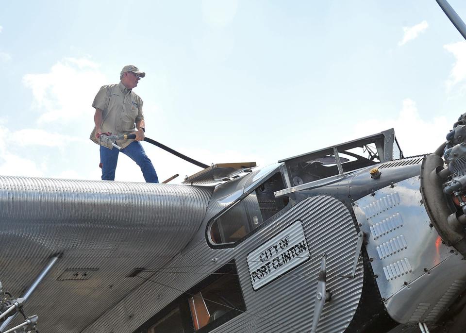 Ford Tri-Motor airplane pilot Gary Baker refuels the 1920s era plane recently when the craft spent a weekend at the Wayne County Airport offering rides.