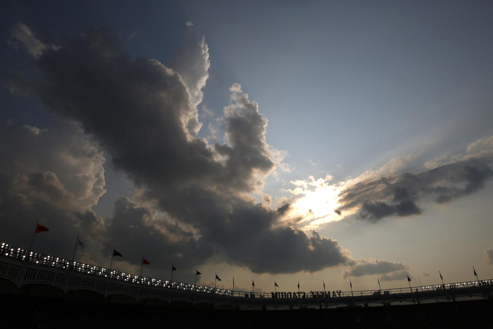 A clearing sky appears over Yankee Stadium after a rain storm moved through clearing a haze of smoke before a baseball game between the Philadelphia Phillies and the New York Yankees, Wednesday, July 21, 2021, in New York. Wildfires in the American West, including one burning in Oregon that's currently the largest in the U.S., are creating hazy skies as far away as New York as the massive infernos spew smoke and ash into the air in columns up to six miles high. (AP Photo/Adam Hunger)