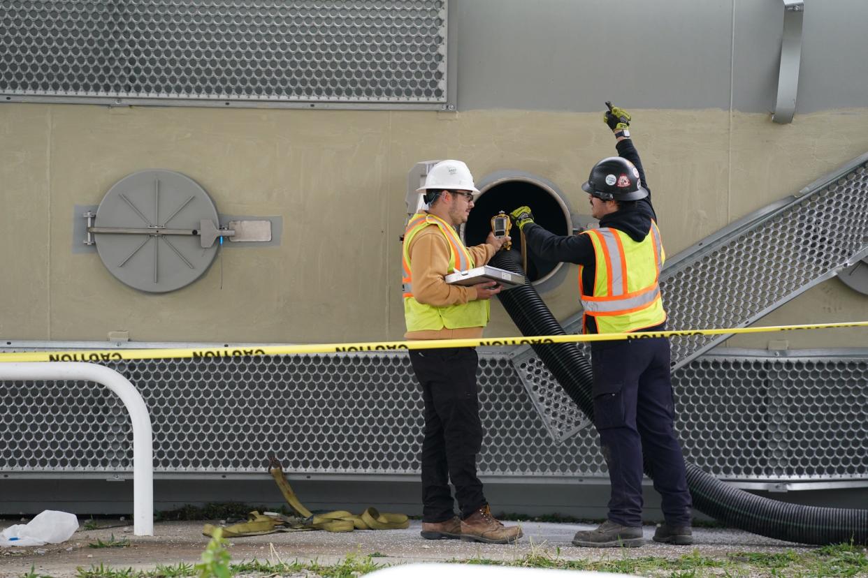 CSX crews work to remove substances from train cars on Sunday following a derailment the night before near the border between Wyoming and Lockland.