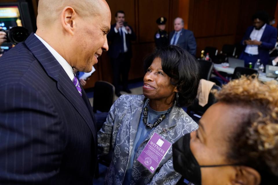 Sen. Cory Booker, D-N.J., talks with Ellery Brown, mother of Supreme Court nominee Ketanji Brown Jackson, during a break in the Senate Judiciary Committee confirmation hearing on Capitol Hill in Washington, Tuesday, March 22, 2022.