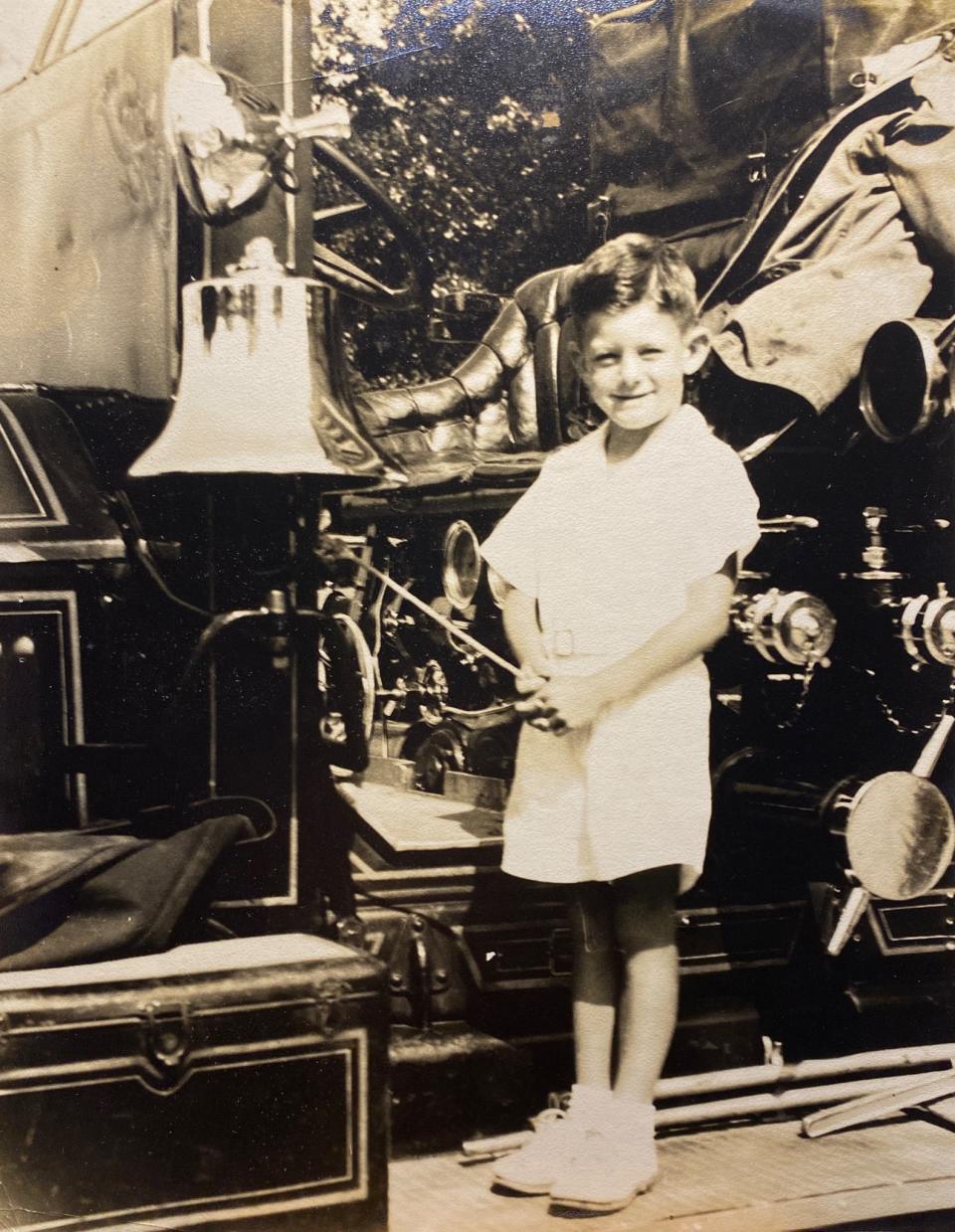 Wayne Doolittle as a child with an antique fire engine.