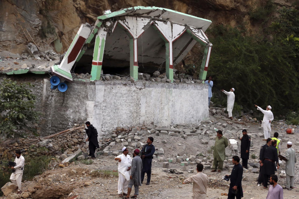 Security personnel inspect at the site of suicide bomber attack inside a roadside mosque in the Khyber district in Khyber Pakhtunkhwa province, of Pakistan, Tuesday, July 25, 2023. A suicide bomber blew himself up inside a roadside mosque when a police officer tried to arrest him after a chase in northwestern Pakistan near the Afghan border on Tuesday, killing the officer, police said. (AP Photo/Muhammad Sajjad)