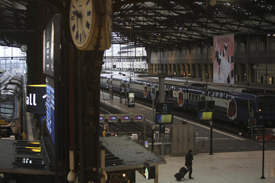 A man walks in the deserted Gare de Lyon train station, Friday, Dec. 6, 2019 in Paris. Frustrated travelers are meeting transportation chaos around France for a second day, as unions dig in for what they hope is a protracted strike against government plans to redesign the national retirement system. (AP Photo/Rafael Yaghobzadeh)