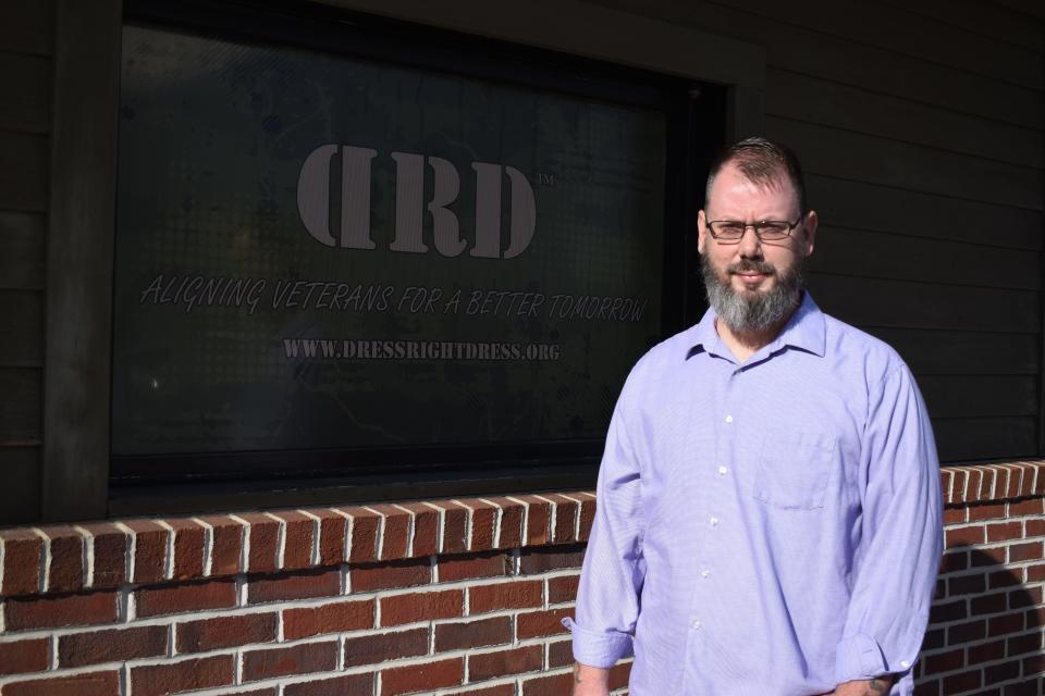 Jeremy Parkins, founder and CEO of Dress Right Dress, poses in front of his business's new central office in Kingston on Dec. 9, 2021.