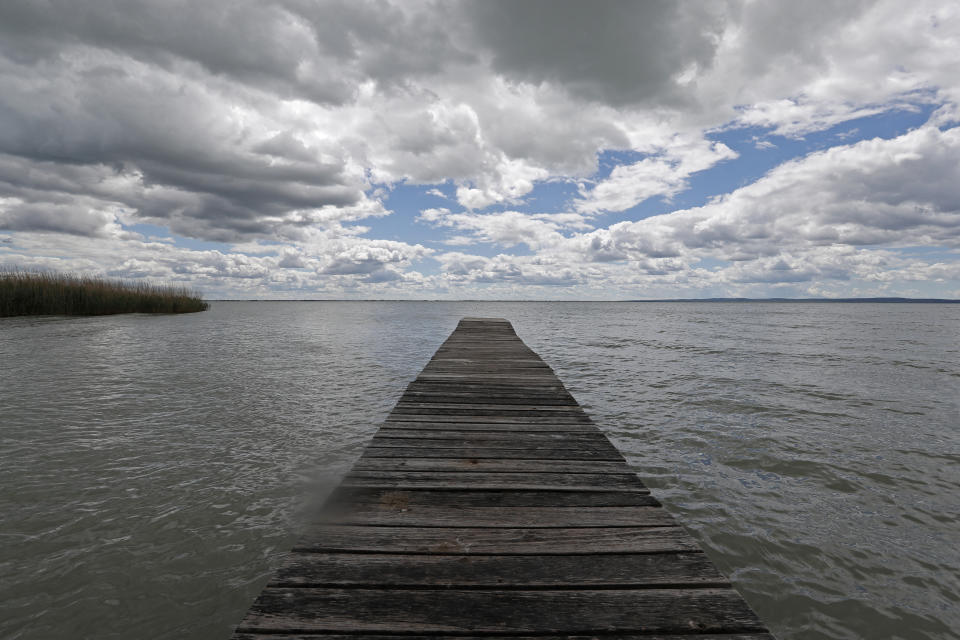 A pier on Lake Balaton in Szigliget, Hungary on May 18, 2021. Lake Balaton is the largest lake in Central Europe and one of Hungary's most cherished natural treasures. But some worry that the lake's fragile ecosystem and the idyllic atmosphere of the quaint villages dotted along its banks are in danger because of speculative developments. (AP Photo/Laszlo Balogh)