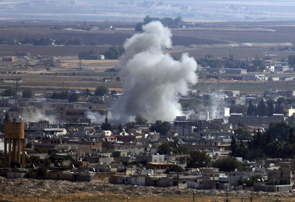 In this photo taken from the Turkish side of the border between Turkey and Syria, in Ceylanpinar, Sanliurfa province, southeastern Turkey, smoke and dust billows from targets in Ras al-Ayn, Syria, caused by bombardment by Turkish forces, Tuesday, Oct. 15, 2019. Turkish artillery on Tuesday pounded suspected Syrian Kurdish positions near the town in northeast Syria amid reports that Kurdish fighters had retaken the town as Turkey pressed ahead with a military incursion that has drawn widespread condemnation. (AP Photo/Cavit Ozgul)