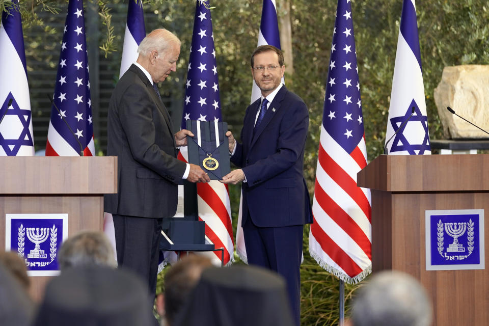 President Joe Biden receives the Israeli Presidential Medal of Honor from Israeli President Isaac Herzog, Thursday, July 14, 2022, in Jerusalem. (AP Photo/Evan Vucci)