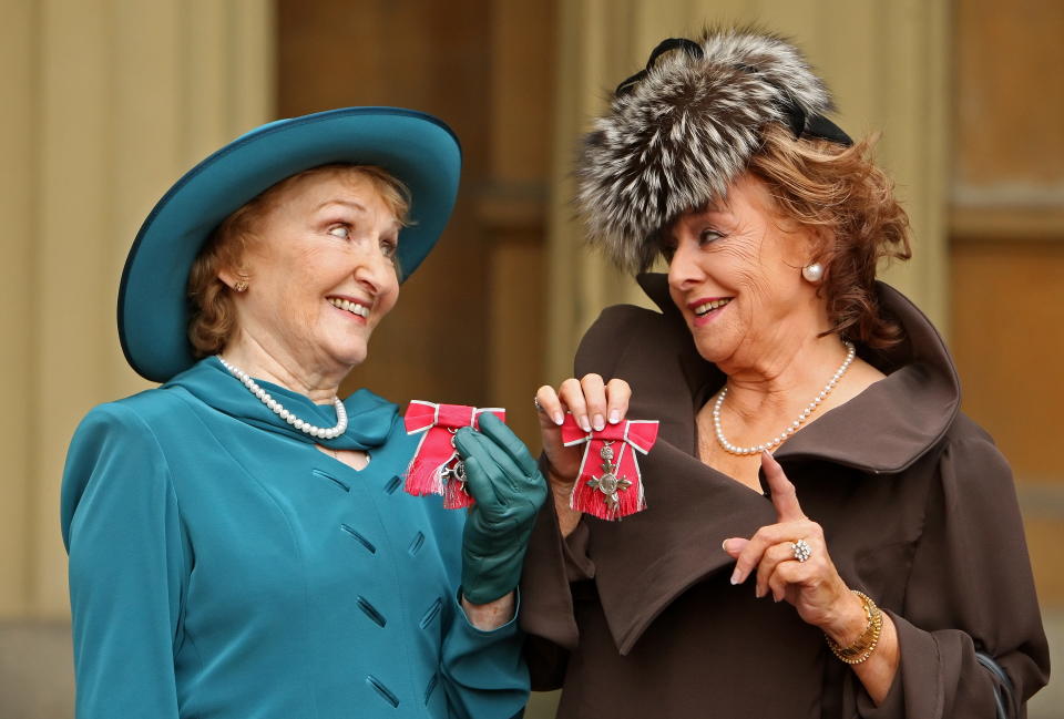 Eileen Derbyshire (L) and Barbara Knox, actresses in British television programme 'Coronation Street', pose for photographers with their MBEs (Member of the British Empire), after they were awarded them by Britain's Queen Elizabeth II, during an Investiture ceremony at Buckingham Palace in London on November 3, 2010.         AFP PHOTO / Dominic Lipinski / Pool (Photo credit should read Dominic Lipinski/AFP via Getty Images)