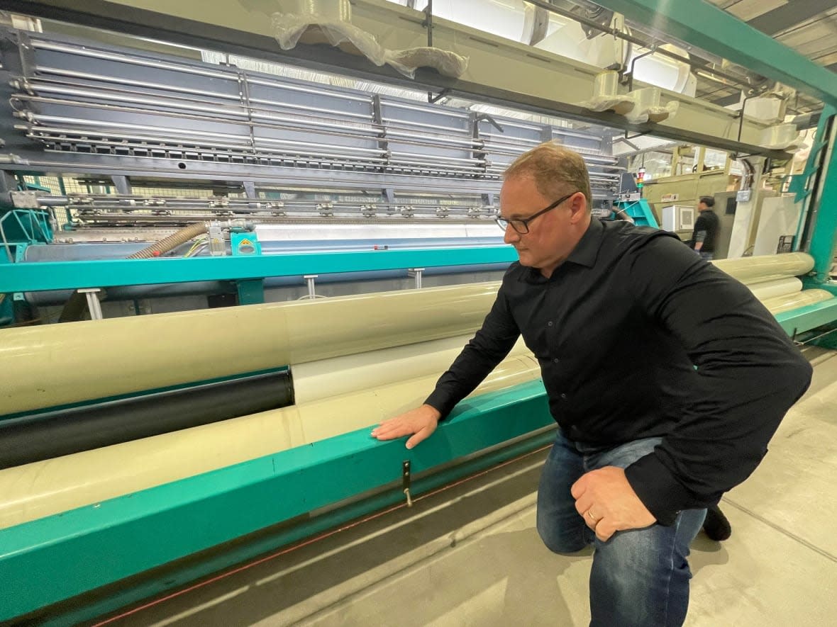 ABC Manufacturing president James Yausie says the big machines are not causing vibrations inside the building. (Dan Zakreski/CBC - image credit)