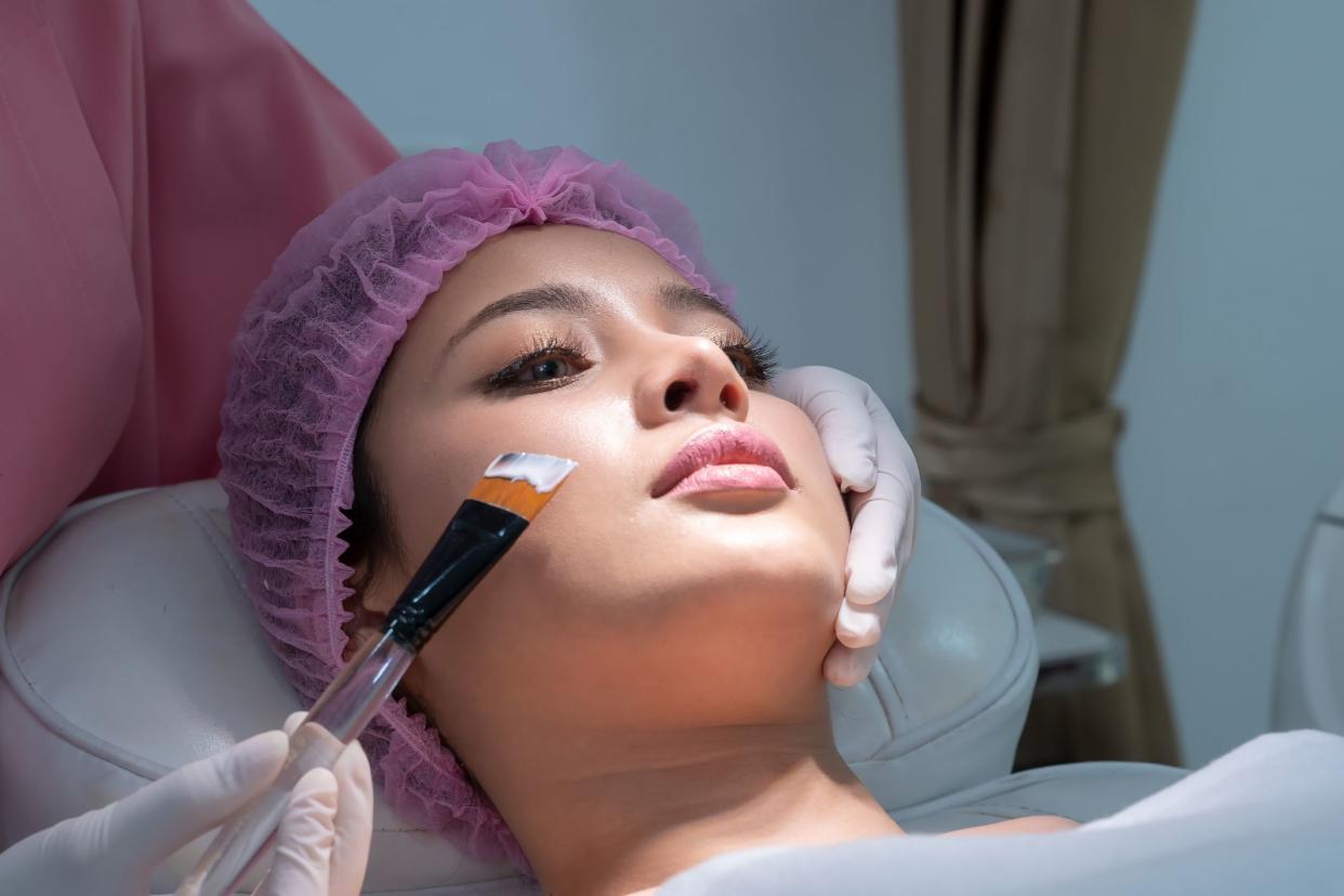 Woman Laying Down Getting a Chemical Peel at the Dermatologist, Looking Up Towards the Right