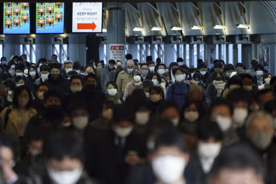 FILE - A station passageway is crowded with commuters wearing face mask during a rush hour Friday, Jan. 8, 2021 in Tokyo. On Friday, March 17, 2023, The Associated Press reported on stories circulating online incorrectly claiming 100 million humans in the same place would emit enough radiation to be deadly. (AP Photo/Eugene Hoshiko, File)