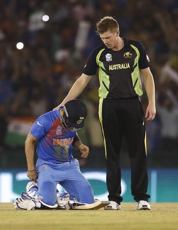 Cricket - India v Australia - World Twenty20 cricket tournament - Mohali, India - 27/03/2016. India's Virat Kohli (L) is congratulated by Australia's James Faulkner after India won the match. REUTERS/Adnan Abidi