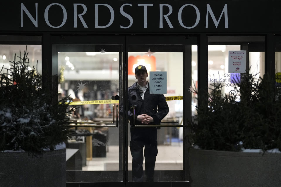 An officer stands inside Nordstrom at Mall of America after a shooting, Friday, Dec. 23, 2022, in Bloomington, Minn. (AP Photo/Abbie Parr)