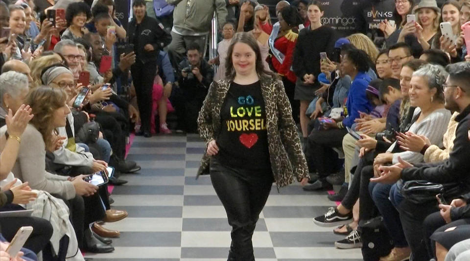 This image from video taken on Wednesday, Oct. 16, 2019 shows a girl participating in the 2nd annual “Gigi’s Playhouse Fashion Show” in New York. Gigi’s Playhouse is an education and achievement center that prepares young people with Down syndrome to engage more fully in their homes, schools and communities. (AP Photo/Gary Gerard Hamilton)