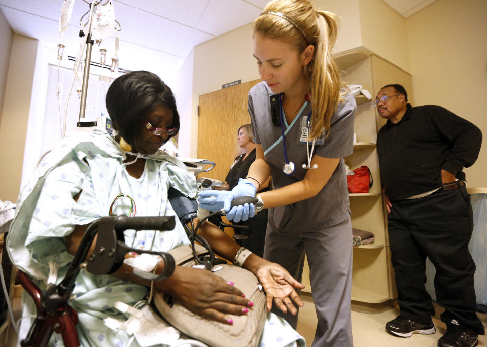 Registered nurse Paige Duracher checks Jacqueline Parker's vitals in the cardiac step-down area of the University of Mississippi Medical Center in Jackson, Mississippi October 4, 2013. Jacqueline Parker is a retired state employee who receives her heath insurance through Medicaid. Mississippi is one of at least 20 states that has decided not to expand Medicaid under the Affordable Care Act, better known as "Obamacare". REUTERS/Jonathan Bachman  (UNITED STATES - Tags: HEALTH POLITICS BUSINESS)