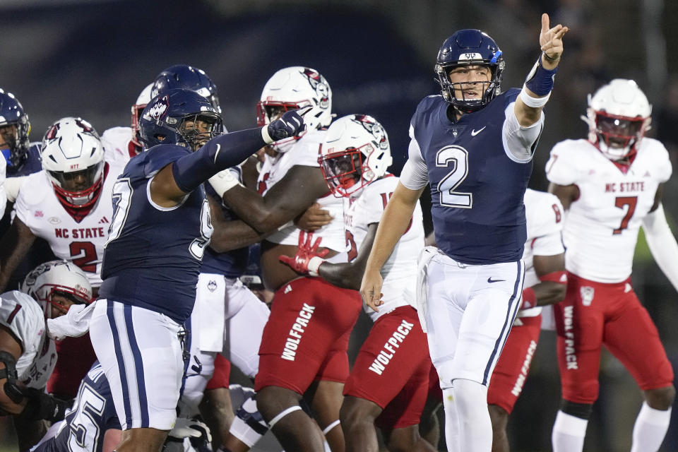 UConn quarterback Joseph Fagnano (2) signals a first down during the first half the team's NCAA college football game against North Carolina State in East Hartford, Conn., Thursday, Aug. 31, 2023. (AP Photo/Bryan Woolston)