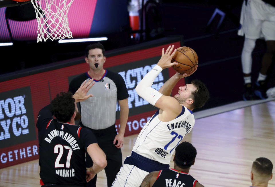 Dallas Mavericks guard Luka Doncic (77) shoots against the Portland Trail Blazers during the second half of an NBA basketball game Tuesday, Aug. 11, 2020, in Lake Buena Vista, Fla. (Kim Klement/Pool Photo via AP)