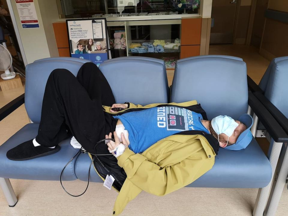 Losier says the port city is "under-served in a very essential way" and she worried about getting care for her husband, pictured in the Prince Rupert Regional Hospital waiting room in June 2022, in the future.