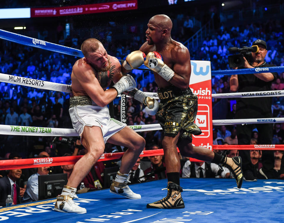 Nevada , United States - 26 August 2017; Floyd Mayweather Jr, right, and Conor McGregor during their super welterweight boxing match at T-Mobile Arena in Las Vegas, USA. (Photo By Stephen McCarthy/Sportsfile via Getty Images)