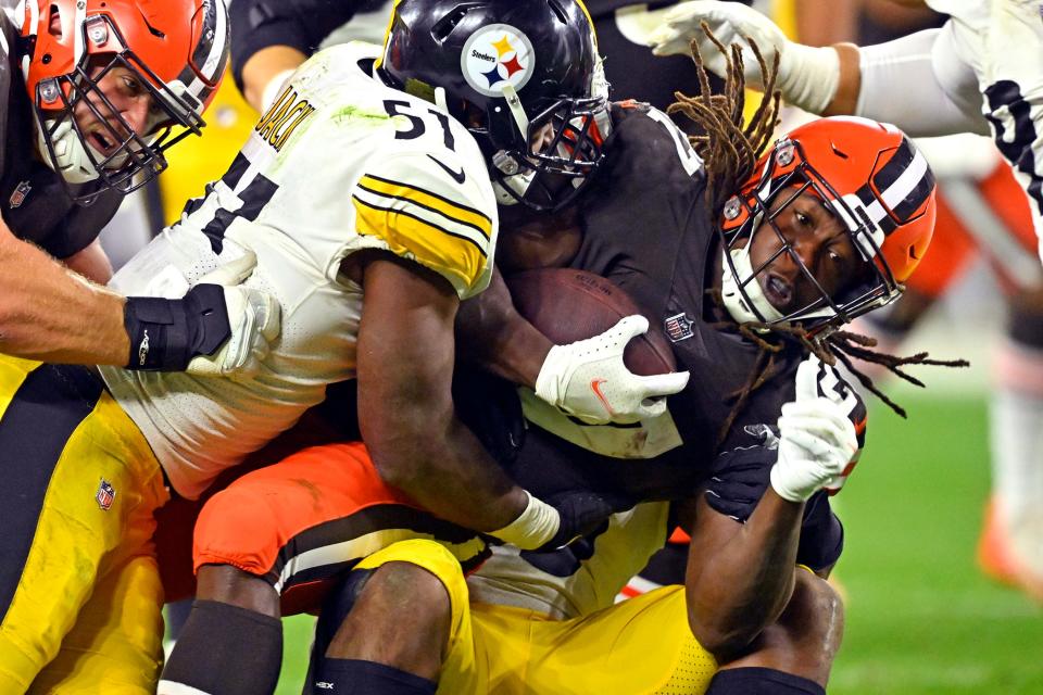 Browns running back Kareem Hunt is tackled by Steelers linebacker Myles Jack (51) after a short second-half gain in Cleveland, Thursday, Sept. 22, 2022.