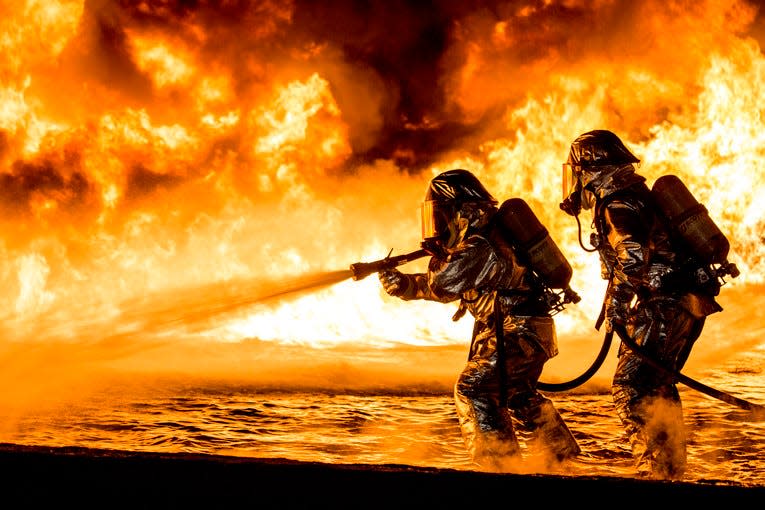 Marines use a fire hose to extinguish a fuel fire during live-burn training at Marine Corps Air Station Futenma in Okinawa, Japan, Jan. 25, 2019.