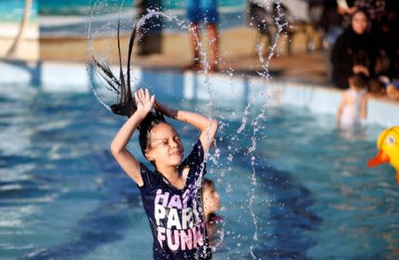 A Palestinian girl plays at Sharm Park Water City, in Gaza July 9, 2018. Picture taken July 9, 2018. REUTERS/Mohammed Salem