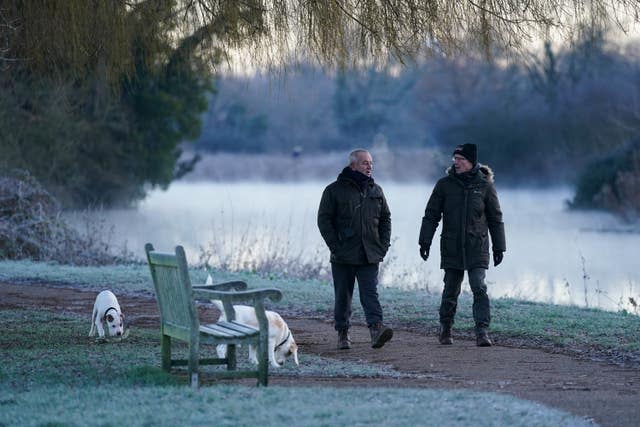 Dog walkers in St Nicholas’ Park in Warwick during a cold and frosty morning