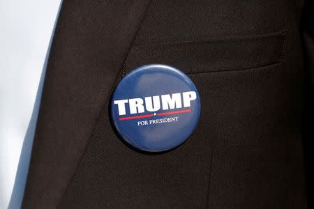 A member of the U.S. Republican party's election campaign team in Israel wears a badge of Republican U.S. presidential nominee Donald Trump during a campaign aimed at potential American voters living in Israel, near a mall in Modi'in, Israel August 15, 2016. REUTERS/Baz Ratner