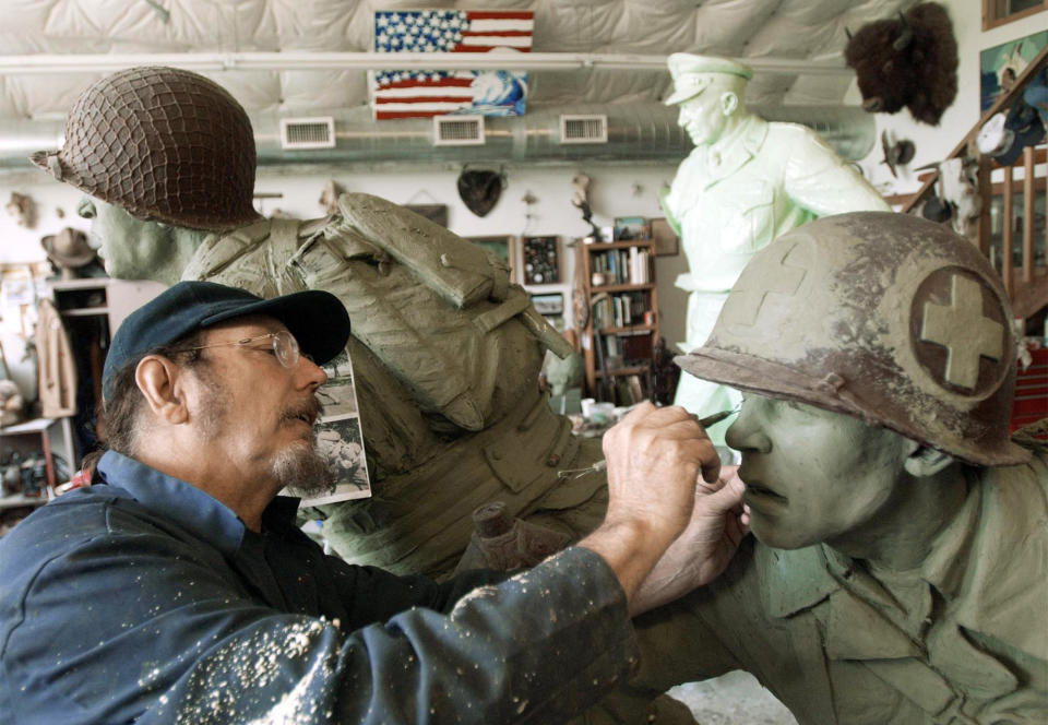 In this June 2002 photo Kansas sculptor Jim Brothers works in Lawrence, Kan., on sculptures of a World War II medic following a soldier onto the shores of France on D-Day, that are destined for the National D-Day Memorial in Bedford, Va. Brothers, whose works are part of historical monuments around the country, died Tuesday, Aug. 20, 2013, at his home in Lawrence where he had been in hospice care, according to a funeral director at Warren McElwain Mortuary. He was 72. (AP Photo/Lawrence Journal World, Mike Yoder)