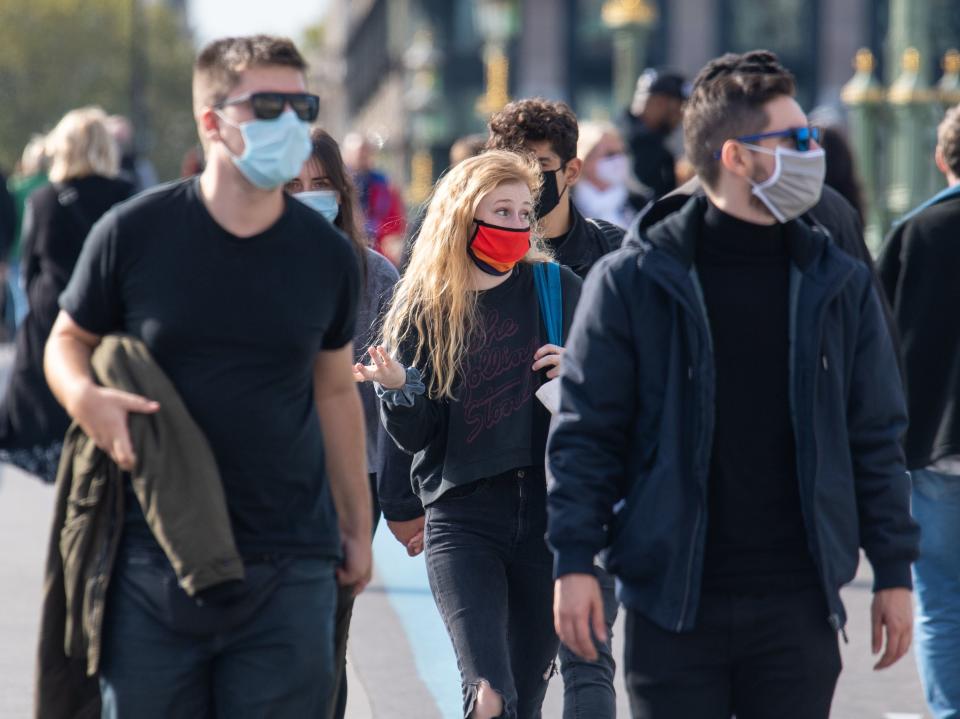 People wearing protective face masks in Westminster, London, after a range of new restrictions to combat the rise in coronavirus cases came into place in England.  (Dominic Lipinski/PA)