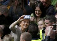 Nicola Sturgeon, the leader of the Scottish National Party, poses for a selfie with a supporter at an election campaign event in Glasgow, Scotland, April 25, 2015. REUTERS/Russell Cheyne