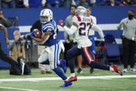 Indianapolis Colts running back Jonathan Taylor (28) runs past New England Patriots cornerback J.C. Jackson (27) on his way to a 67-yard touchdown during the second half of an NFL football game Saturday, Dec. 18, 2021, in Indianapolis. (AP Photo/AJ Mast)