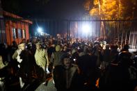 Police gather outside a gate of the Jawaharlal Nehru University (JNU) following alleged clashes between student groups in New Delhi on January 5, 2020. - At least 23 people were hurt at a prestigious Indian university on January 5 in what police said were clashes between rival student groups. The incident at JNU is the latest in a series of violent clashes and protests at different Indian universities in the last few weeks, with many student activists and opposition demonstrating against Modi government's controversial new citizenship law. (Photo by STR / AFP) (Photo by STR/AFP via Getty Images)